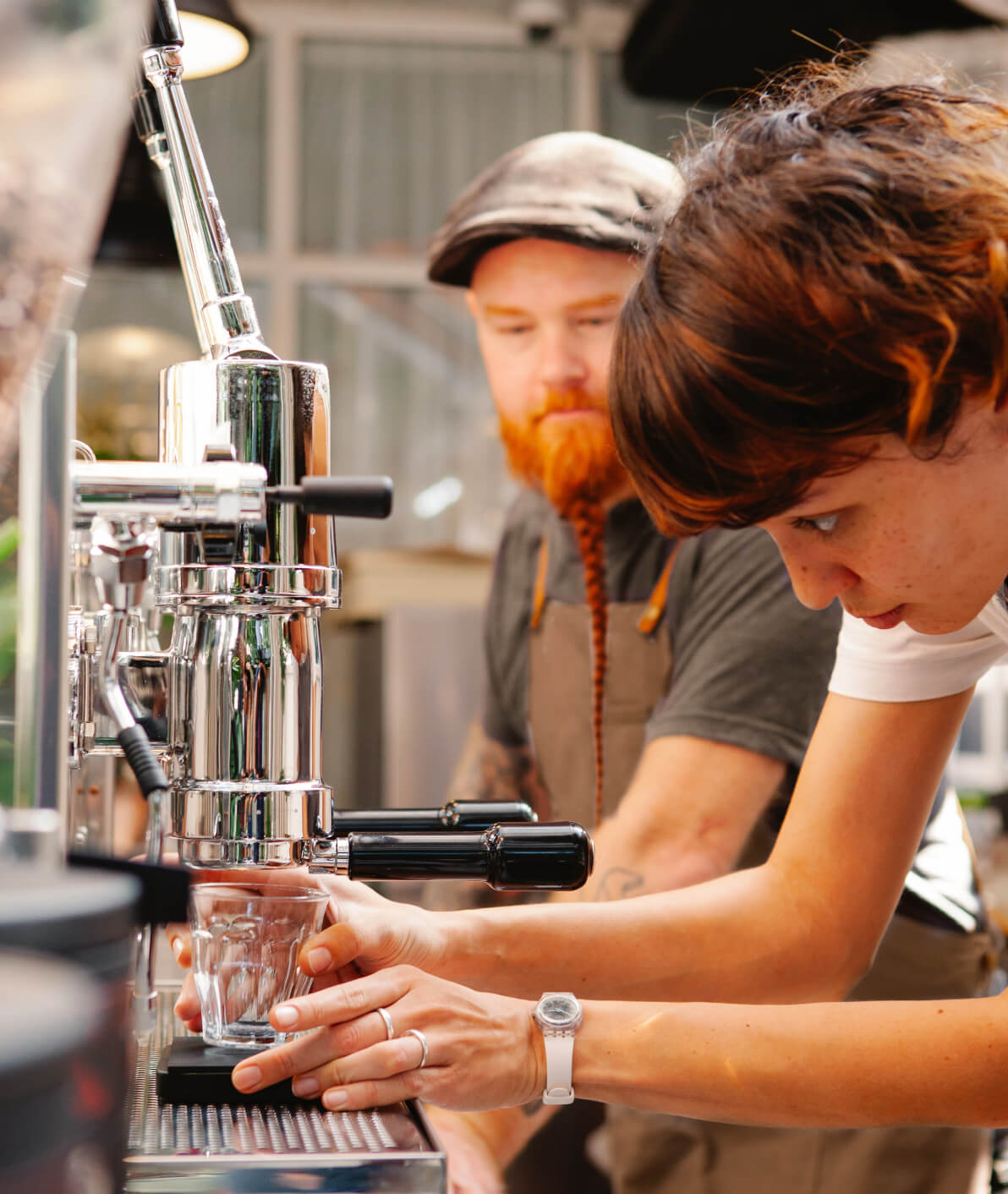 Image of two baristas at work