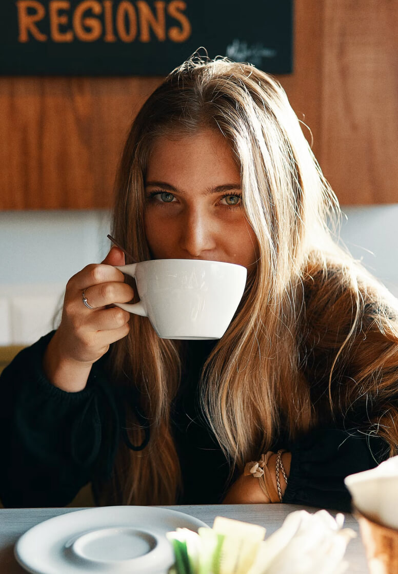 Image of a woman enjoying her coffee