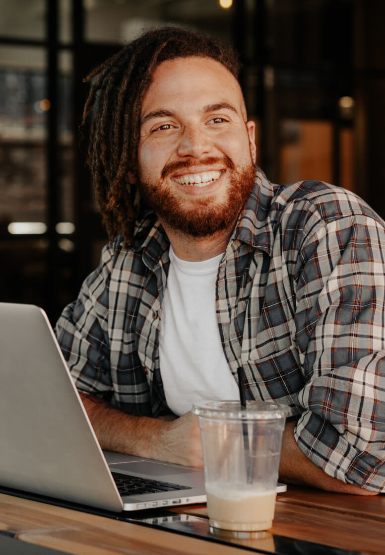 Image of a man smiling and enjoying his time at the coffee shop